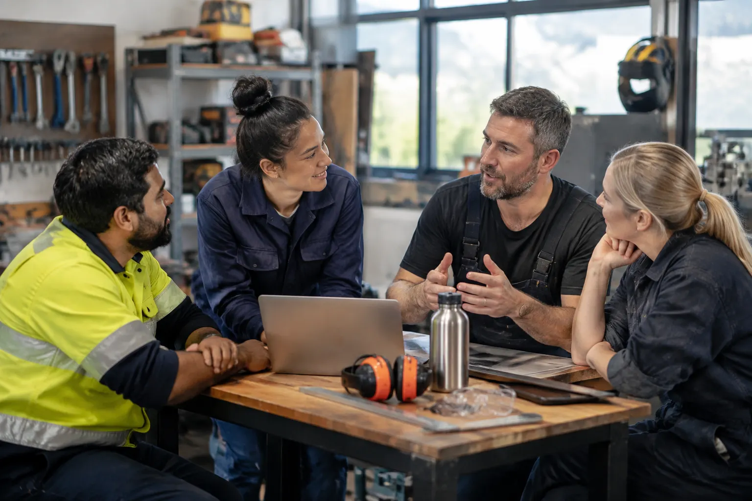 Skilled professionals discussing career planning in a modern workshop meeting area